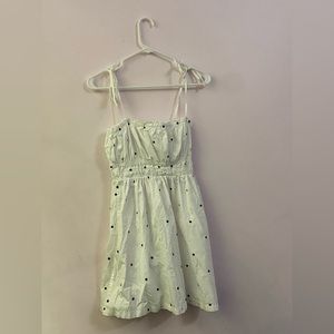white polka dot sundress, spaghetti strap tie sleeves, ruching on bust and neck